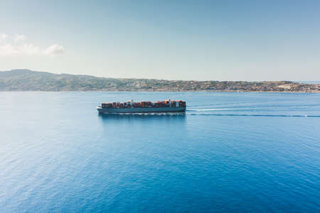 container cargo ship in the ocean. Aerial view.