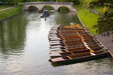 Punting boats with names in a row docked in the river in Cambridge, UKのeditorial素材