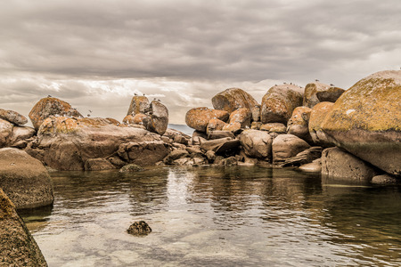 Rocks in Insuela, Palmeira, in the city of Riveira, Galicia (Spain). in august morning cloudy day in the beautiful Arousa River.の写真素材