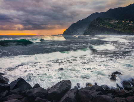 Beautiful seascape with stormy waves at sunset in Madeira, Portugalの写真素材