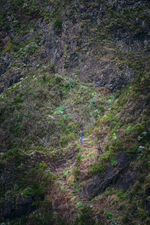 Person hiking on a trail in the mountainsの写真素材
