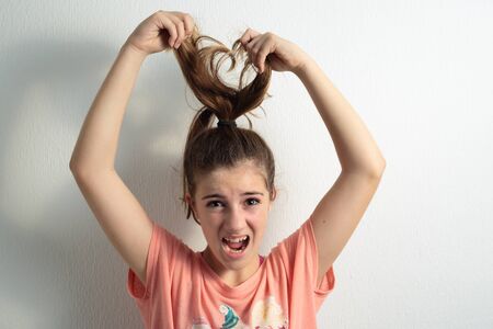 teenager pulling at her hairの写真素材