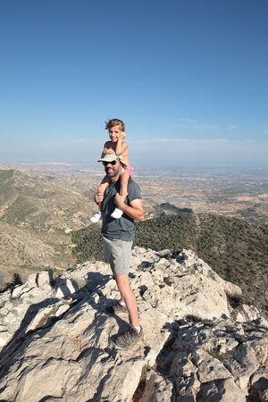 father and daughter hiking in the mountainsの写真素材