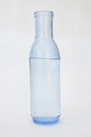 blue glass bottle with waterの写真素材