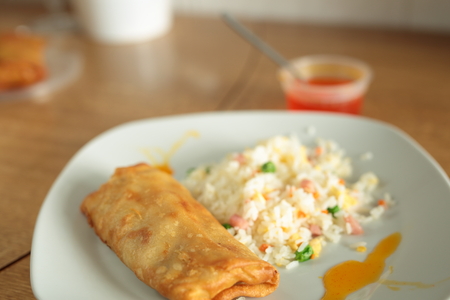 Chinese fried rice and spring roll with sweet and sour sauceの写真素材