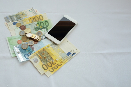 phone with money on white background