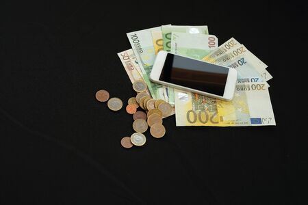 phone with money on black backgroundの写真素材
