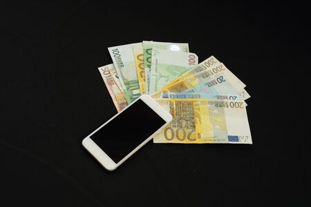 phone with money on black background