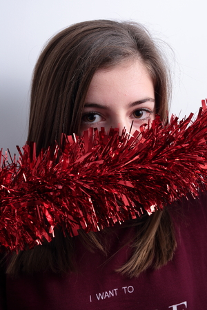 teenager with a garland Christmas decorationの写真素材