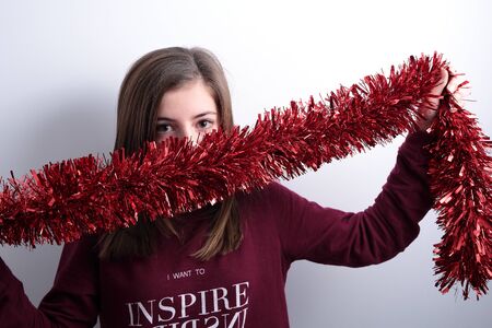 teenager with a garland Christmas decorationの写真素材