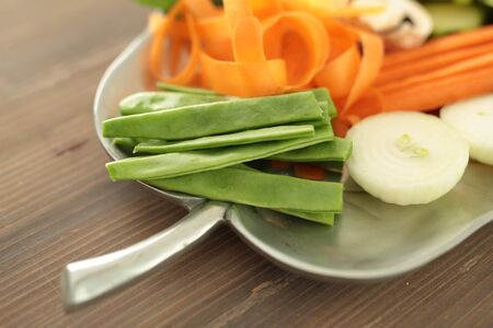 tray with fresh cut vegetables to cook