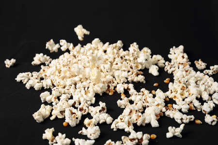 Popcorn in a pile on black backgroundの写真素材