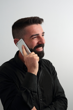 Smiling man talking on the phoneの写真素材