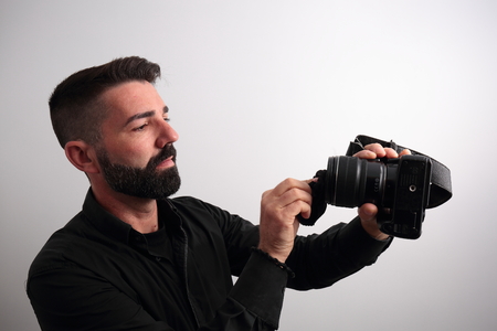 Man cleaning the camera lensの写真素材