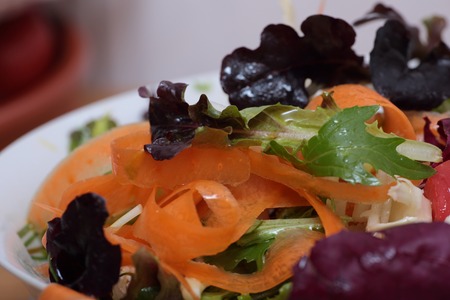 Mixed vegetable salad dressed with organic olive oil and unrefined saltの写真素材