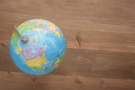 Globe isolated on wooden backgroundの写真素材