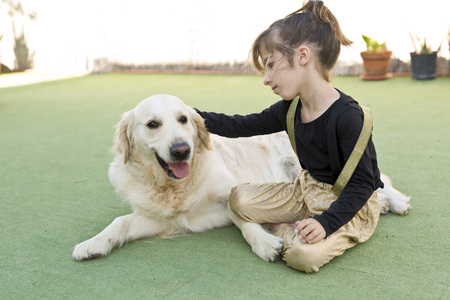 Little girl with her dog with signs of affectionの写真素材