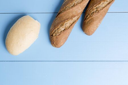 bread on a wooden background painted blueの写真素材
