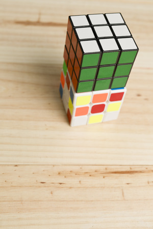 Elche, Spain. May 26, 2016: Two rubik cubes on a background of pine wood.のeditorial素材