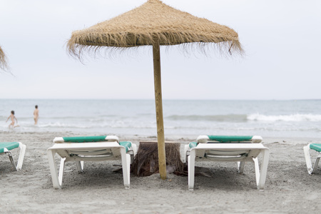 Thatched umbrellas on a beach in Santa Pola, Spainの写真素材