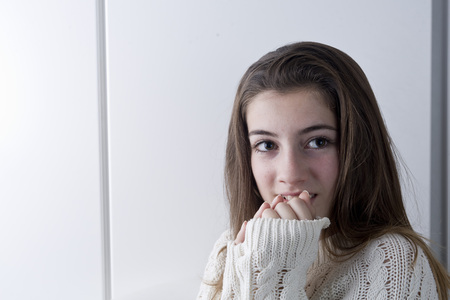 Portrait of adolescent with long chestnut hair and jersey clear. Light of Studio and shooting horizontally.の写真素材