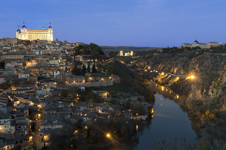 View of the city of Toledo, Spain at night. Horizontal shot with warm tones and blue.の写真素材