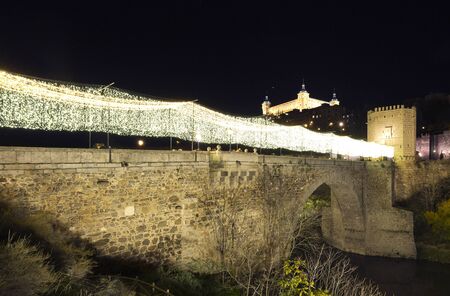 Bridge over the River Tajo in Toledo, Spain. Horizontal shot at night with the Alcazar in the background.のeditorial素材