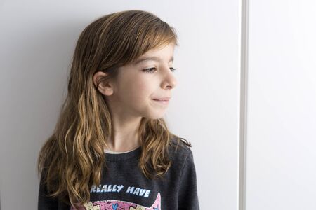 Portrait of little girl on a white background with soft artificial light