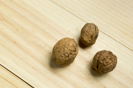 Nuts on a pine wood background. Artificial lighting with flax.