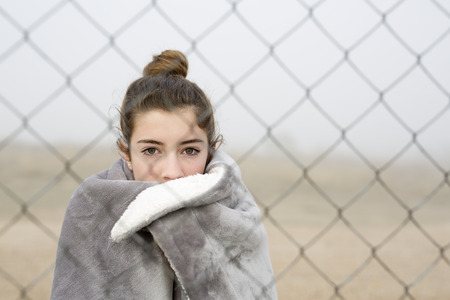 Girl behind a fence. Horizontal shot with natural light.の写真素材