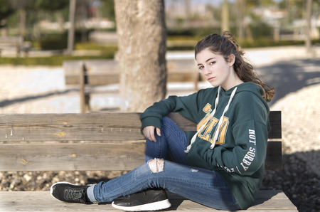 Portrait of a young girl in a park. Horizontal shot with natural light.の写真素材