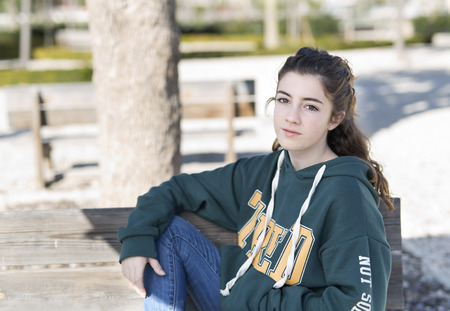 Portrait of a young girl in a park. Horizontal shot with natural light.の写真素材
