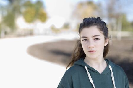 Portrait of a young girl in a park. Horizontal shot with natural light.の写真素材