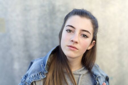 Close-up of young woman with serious face. Horizontal shot.
