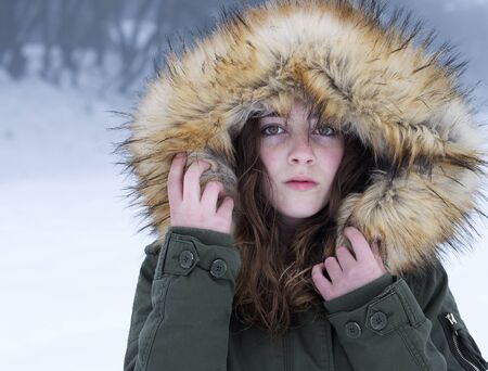Sheltered teenager on a snowy day in the province of Alicante, Spain. Horizontal shotの写真素材