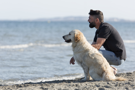 Man with his dog on a beach. Take place in Santa Pola province of Alicante, Spain.の写真素材