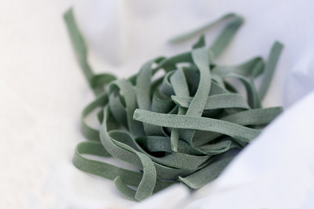 Uncooked organic fresh pasta on a light background. Horizontal shot with natural light.の写真素材