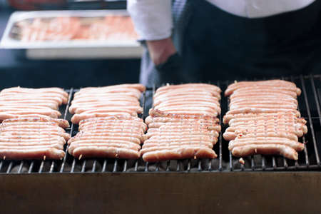 Grill with Belgian sausages cooking on the grill. Shot with natural light and selective focus.の写真素材