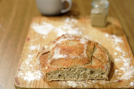 Homemade sourdough bread in a conventional oven. Daytime shot with natural light and selective focus.の写真素材