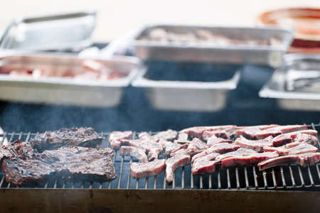 Meat being grilled on a barbecue in a Belgian restaurant. Daytime shot with natural light and selective focus.の写真素材