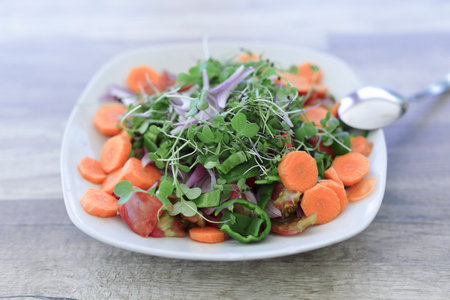 Vegan salad with organic products from Alicante, on a natural wooden table.の写真素材