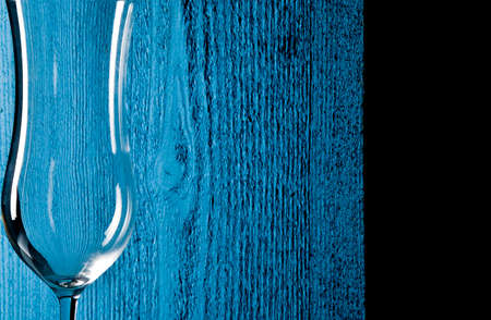 Closeup glass with blue wooden texture backgroundの写真素材