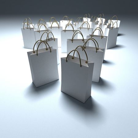 White shopping bags on a white background in a pool of lightの写真素材