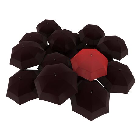 Group of black umbrellas with a red one standing outの写真素材
