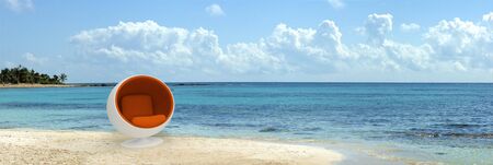 A spherical designer seat in the middle of a tropical beachの写真素材