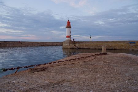 Red and white lighthouse at the harbour の写真素材