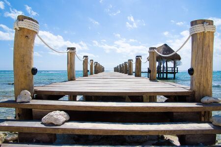 Wooden pier on a tropical beachの写真素材