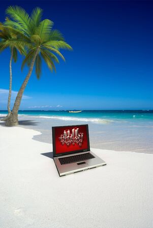 3D rendering of a computer on a tropical beachの写真素材