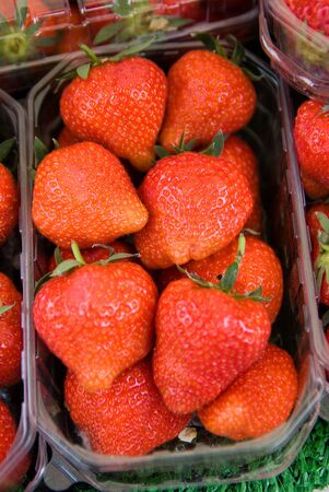 Strawberry trays in a market stallの写真素材