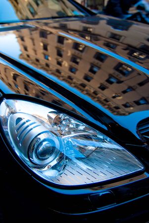 Building reflection on a black carの写真素材
